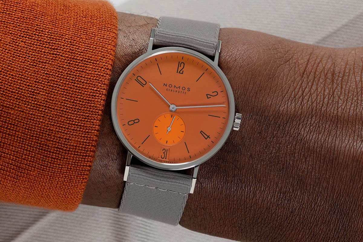 08_NOMOSGlashuette_179_S13_Tangente_38_Datum_Poporange_175_Years_Watchmaking_wristshot.jpg